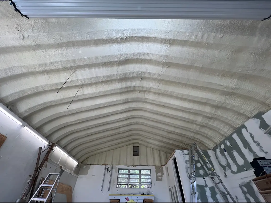 Spray polyurethane foam applied to the underside of a metal roof deck in Fort Carson
